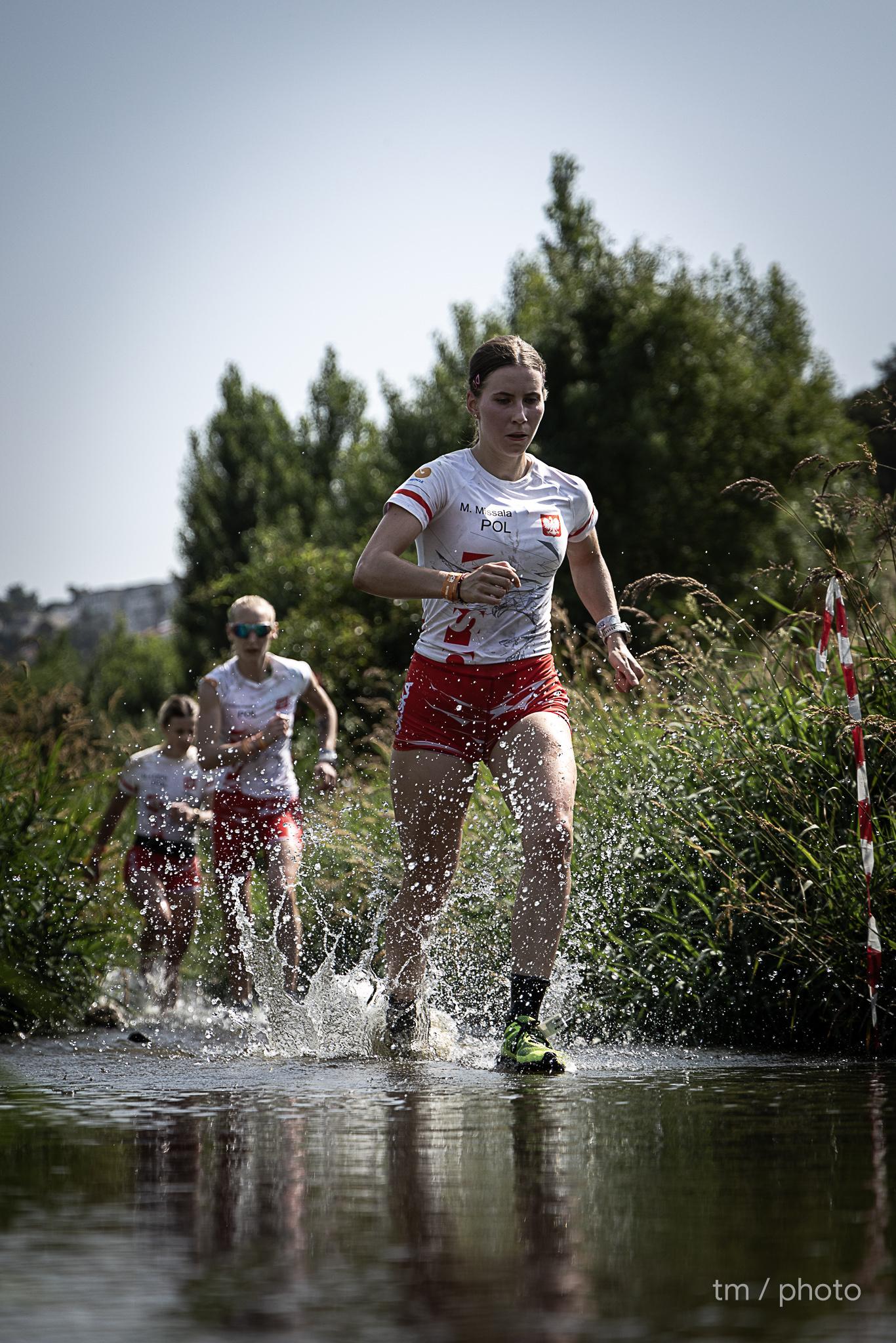 Athlete conquering rope climb obstacle at OCR event with focus and strength